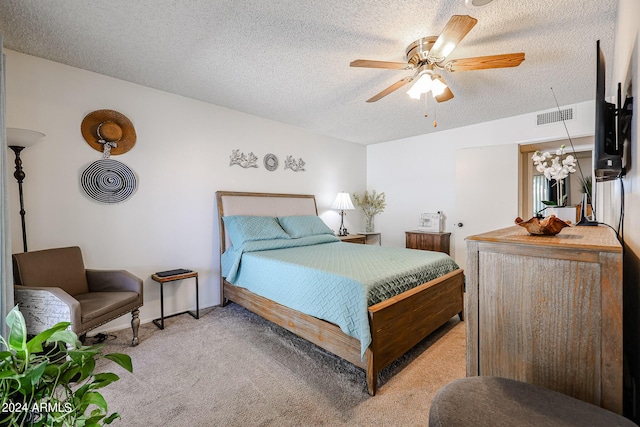 bedroom with light carpet, a textured ceiling, and ceiling fan