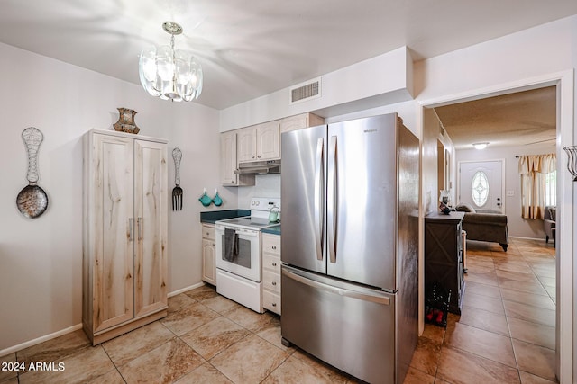 kitchen with a notable chandelier, white cabinets, decorative light fixtures, stainless steel fridge, and white range with electric stovetop