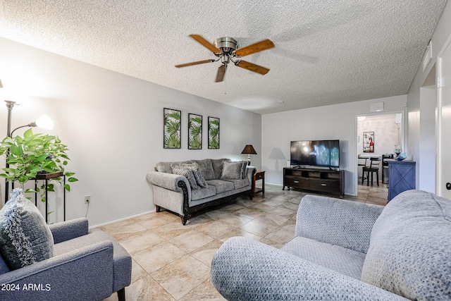 living room featuring a textured ceiling and ceiling fan