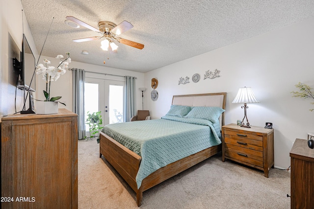 bedroom featuring access to exterior, a textured ceiling, and ceiling fan