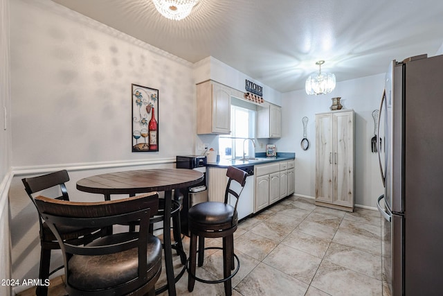 kitchen featuring sink, hanging light fixtures, stainless steel fridge, a chandelier, and light tile patterned flooring