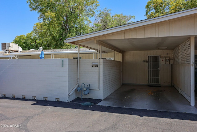 view of side of home with a carport