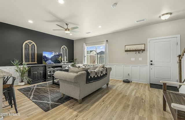 living room featuring ceiling fan and light wood-type flooring