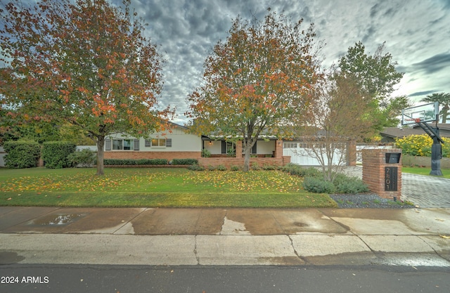 obstructed view of property featuring a front lawn