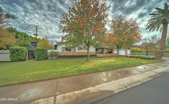 obstructed view of property featuring a front yard