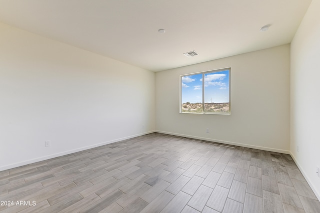 spare room featuring light wood-type flooring