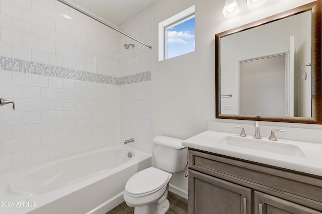 full bathroom with vanity, toilet, wood-type flooring, and tiled shower / bath combo