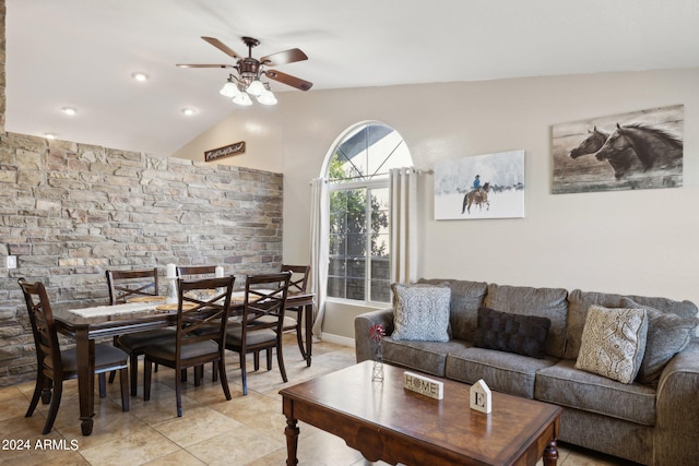 living room featuring ceiling fan, lofted ceiling, and light tile patterned floors