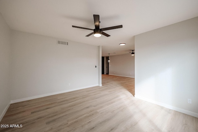 empty room with ceiling fan and light hardwood / wood-style floors