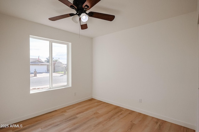 empty room featuring ceiling fan and light hardwood / wood-style floors