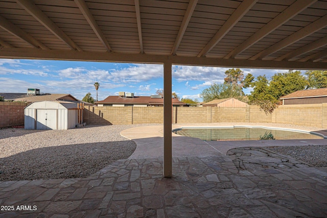 view of patio featuring a shed