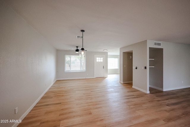 unfurnished living room featuring light wood-type flooring and ceiling fan