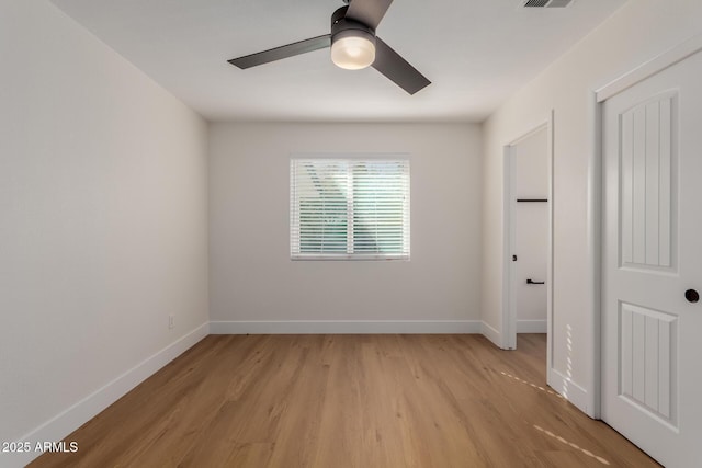 spare room featuring ceiling fan and light hardwood / wood-style floors