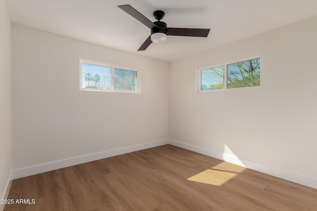 spare room featuring ceiling fan and light hardwood / wood-style flooring