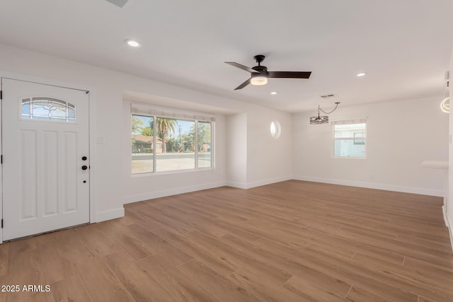 foyer featuring plenty of natural light, ceiling fan, and light hardwood / wood-style flooring