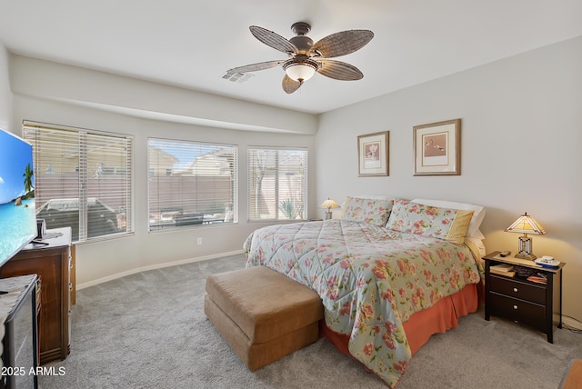 bedroom with visible vents, baseboards, light colored carpet, and ceiling fan