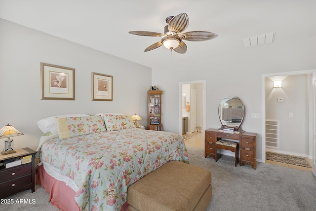 bedroom with visible vents, light carpet, ensuite bath, and a ceiling fan