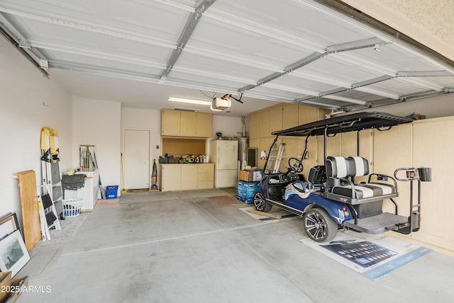 garage with water heater, a garage door opener, and freestanding refrigerator