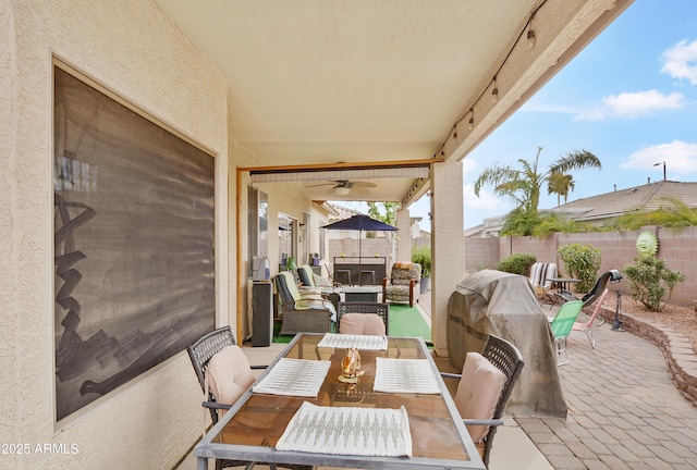 view of patio / terrace featuring an outdoor living space, a ceiling fan, a fenced backyard, and outdoor dining space