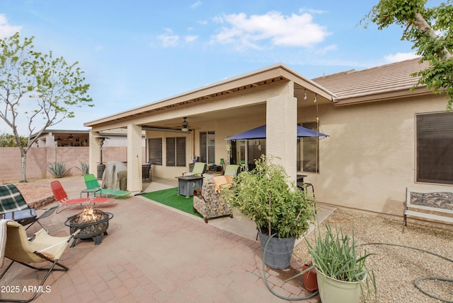 view of patio featuring a fire pit and fence