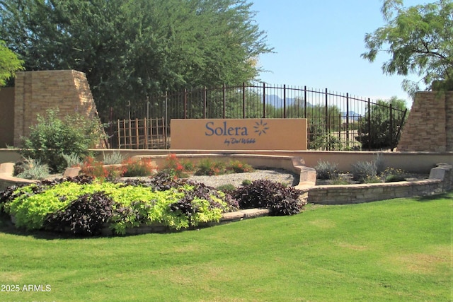 community sign with a yard and fence