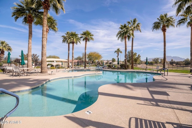 pool featuring a patio and fence