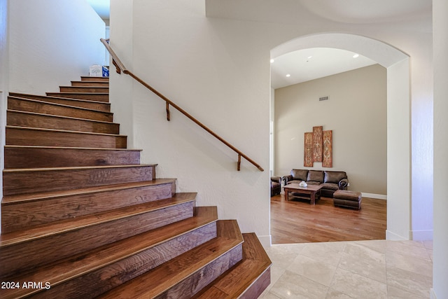 stairs featuring hardwood / wood-style floors