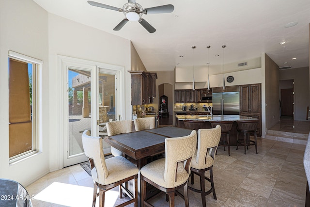 dining area with ceiling fan and sink