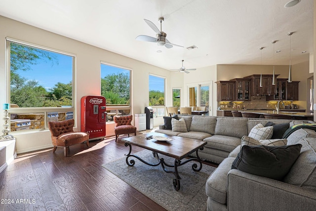 living room with ceiling fan, dark hardwood / wood-style flooring, and a healthy amount of sunlight