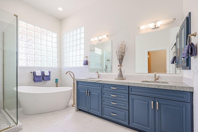 bathroom with vanity and separate shower and tub