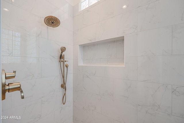 interior details featuring tiled shower