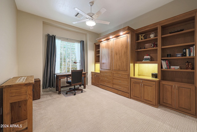 carpeted home office with ceiling fan