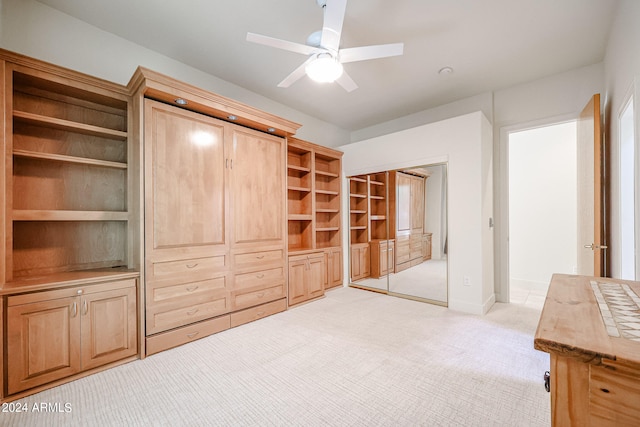 interior space with ceiling fan and light colored carpet