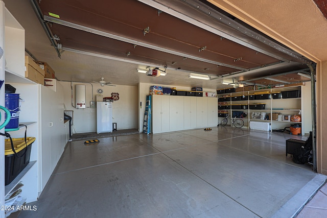 garage with a garage door opener and water heater