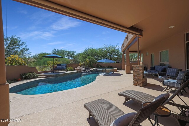 view of swimming pool featuring a patio and an outdoor hangout area