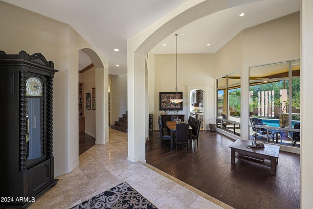 interior space with light hardwood / wood-style flooring and a high ceiling