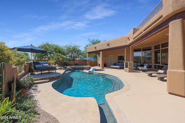 view of swimming pool with outdoor lounge area and a patio area