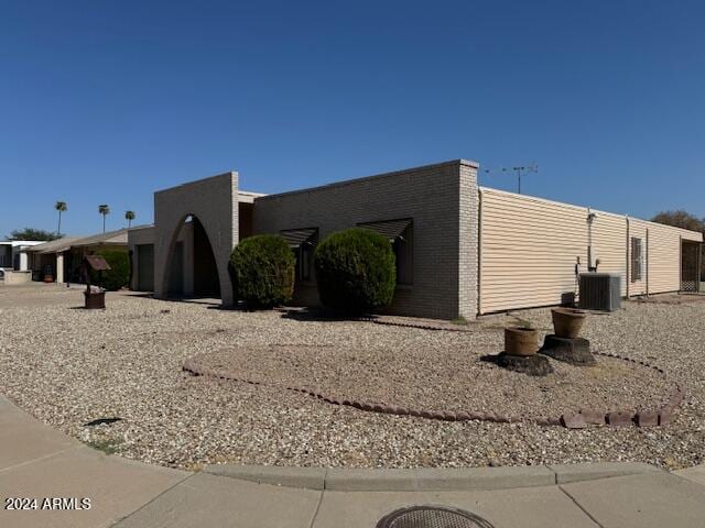 view of side of property featuring central AC unit