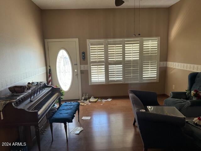 living area featuring hardwood / wood-style floors and ceiling fan