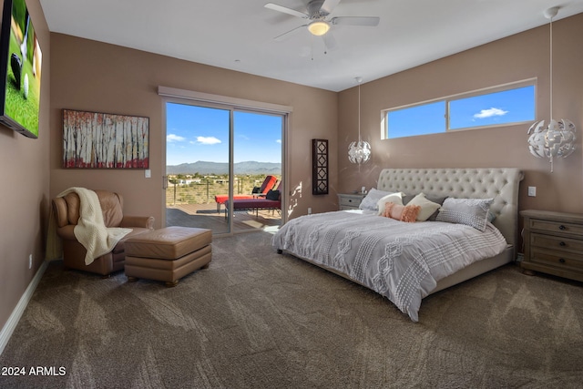 bedroom with a mountain view, ceiling fan, access to outside, and multiple windows