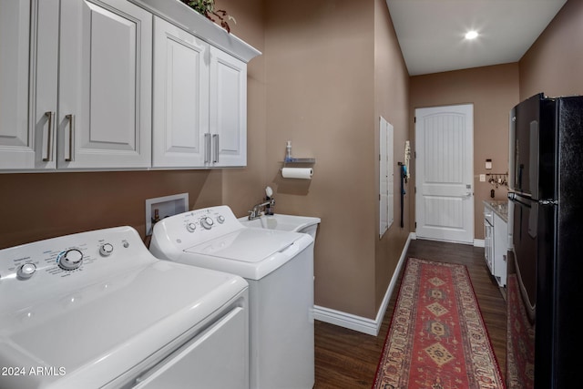 washroom featuring washer and dryer, dark hardwood / wood-style flooring, and sink