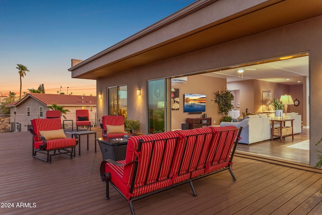 deck at dusk with an outdoor hangout area