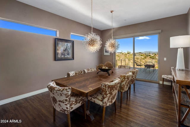 dining room featuring dark hardwood / wood-style flooring and an inviting chandelier