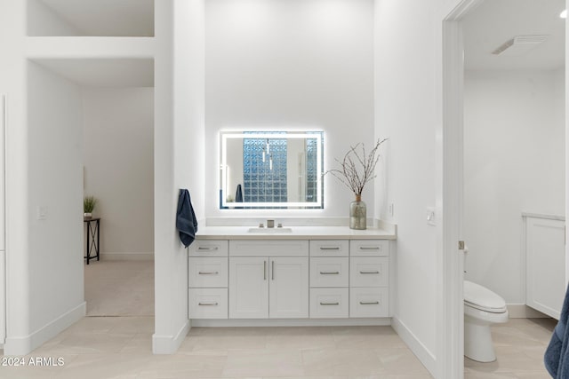 bathroom featuring tile patterned flooring, vanity, and toilet