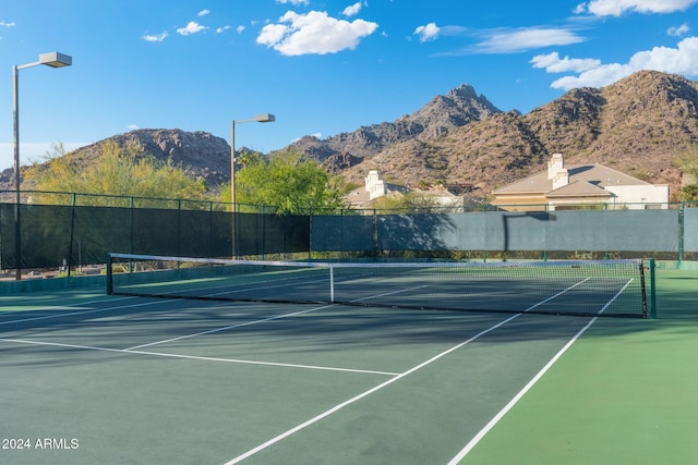 view of tennis court with a mountain view