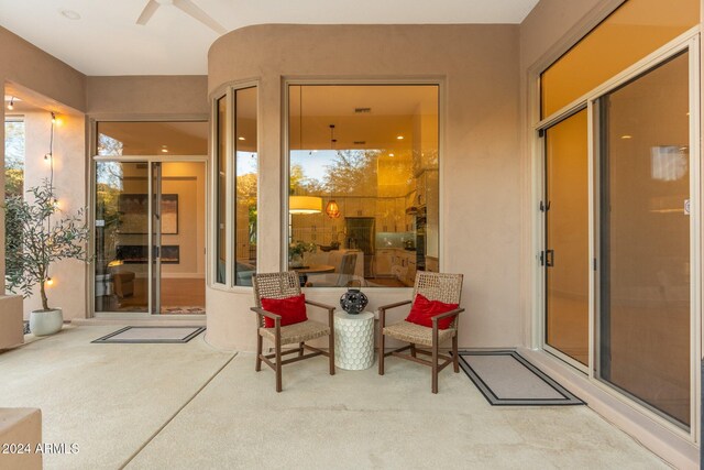 property entrance with ceiling fan and a patio area