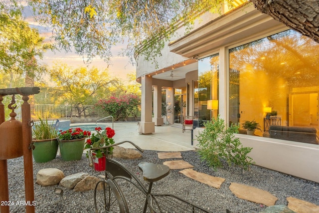 view of patio terrace at dusk