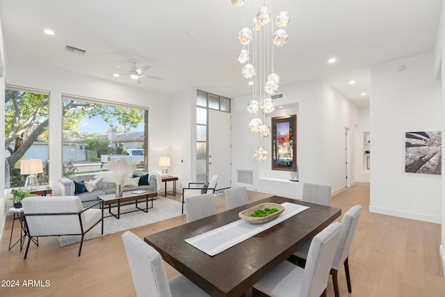 dining room with light hardwood / wood-style floors and ceiling fan