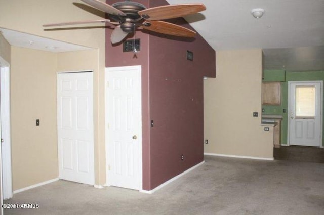 3301 E Earll Dr Unit 219, Phoenix, AZ 85018 - unfurnished living room with ceiling fan, carpet floors, baseboards, and vaulted ceiling