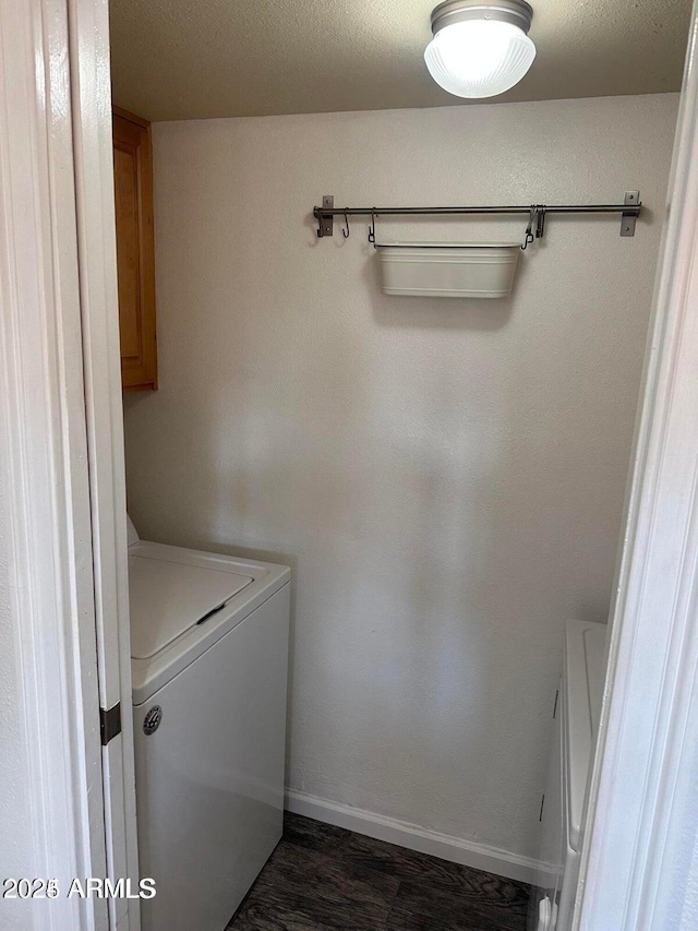 clothes washing area with cabinets